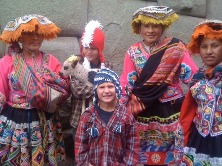 natives in peru with llamas