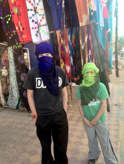 Kids in turbans, getting ready for camping in the Sahara Desert in Morocco