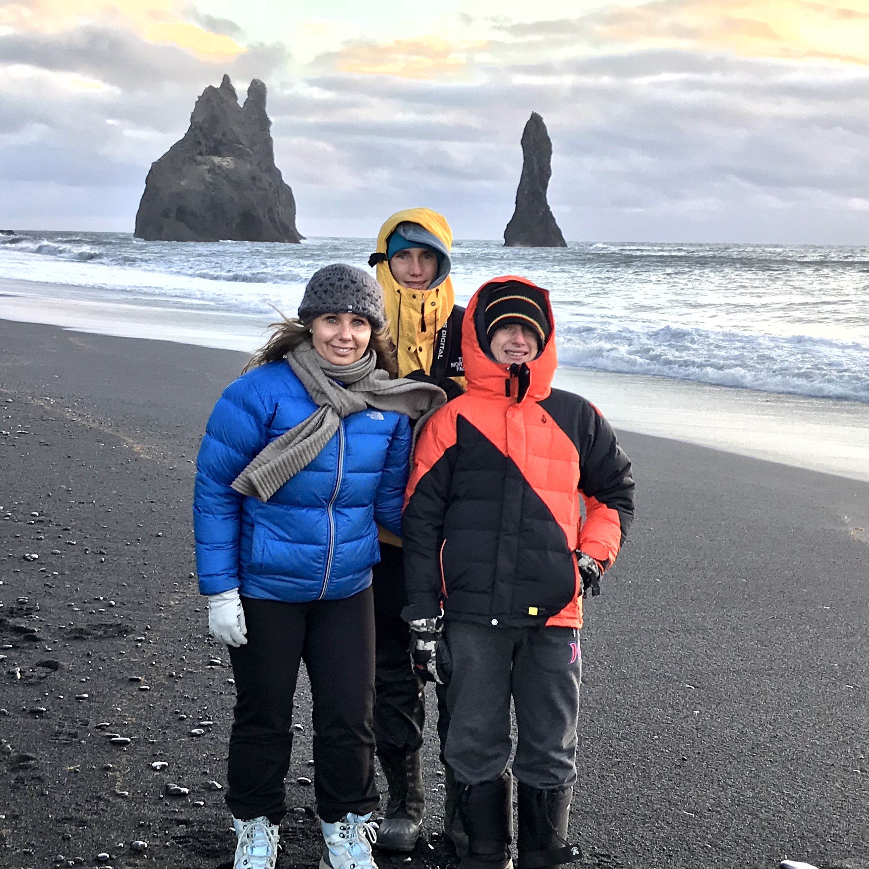 Family on the black sand beach, Iceland